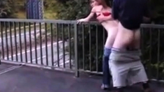 Redhead street whore serves customer outdoor